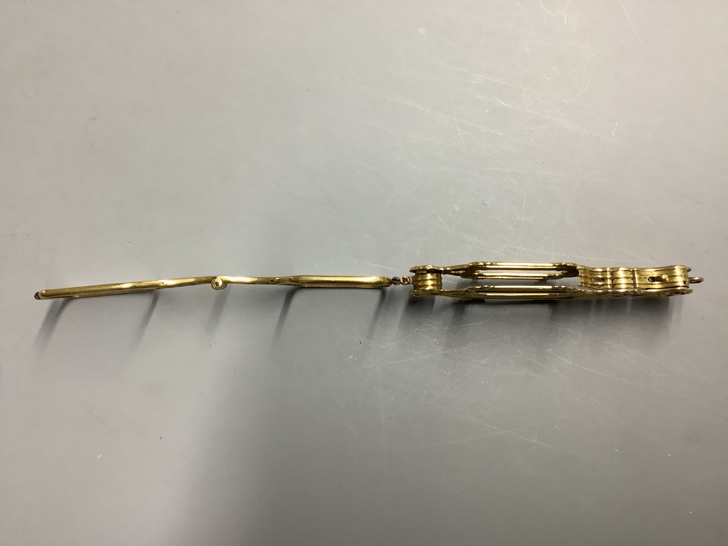 A late 19th century French yellow metal (18ct poincon mark) lorgnette and a yellow metal overlaid eye glass.